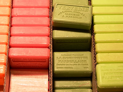 four lanes of assorted-color soap bar nicely stacked on brown cardboard box