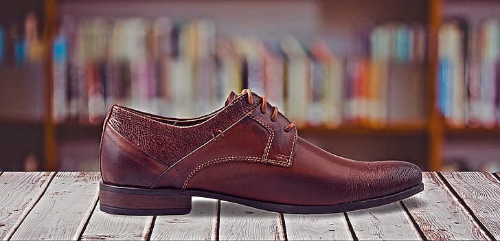 selective focus photography of brown leather dress shoe