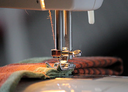 brown and green textile on sewing machine