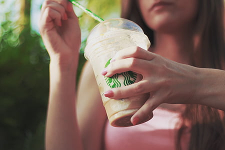 woman holding Starbucks cup