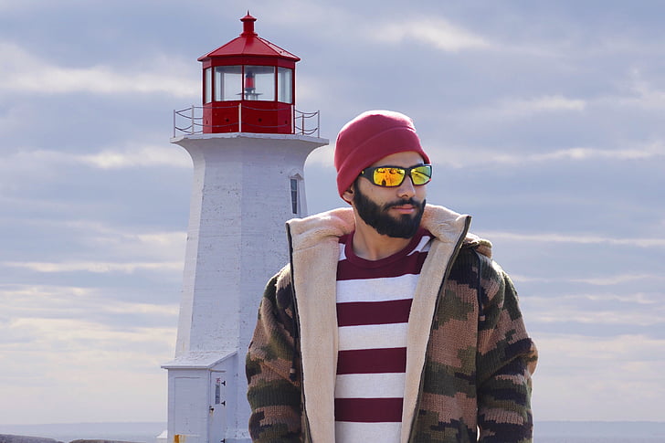 man standing near lighthouse