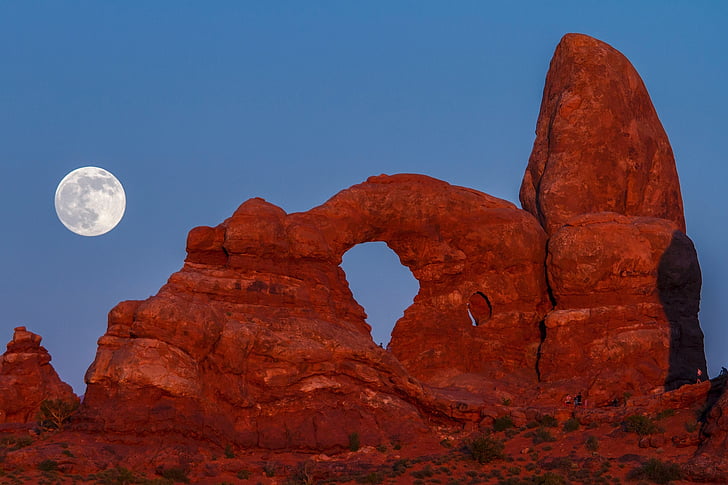 brown rock formation and moon photo
