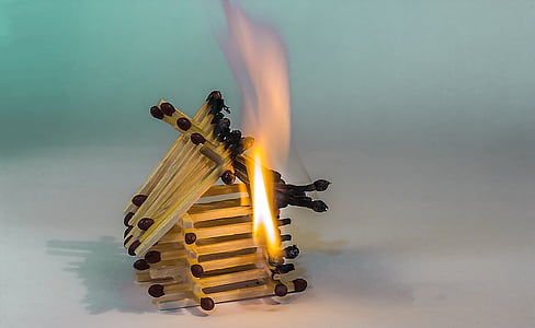 burning matchstick house photograph