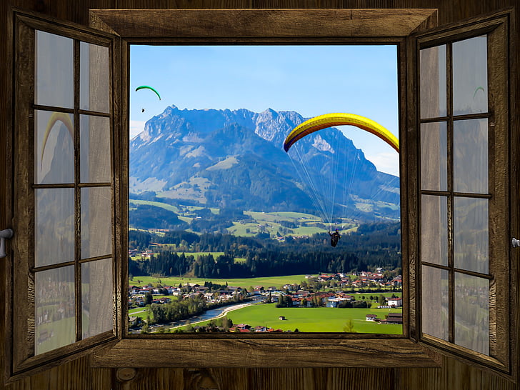man paragliding view front the window