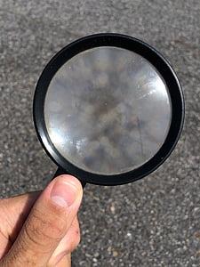 person holding black magnifying glass