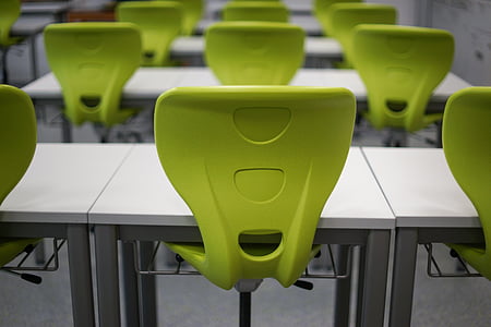 tilt shift photo of white metal tables with green plastic chairs