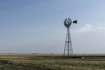 gray windmill on grass field