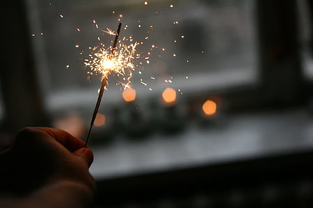 person holding lighted sparkler