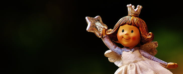 girl angel holding star figurine closeup photo
