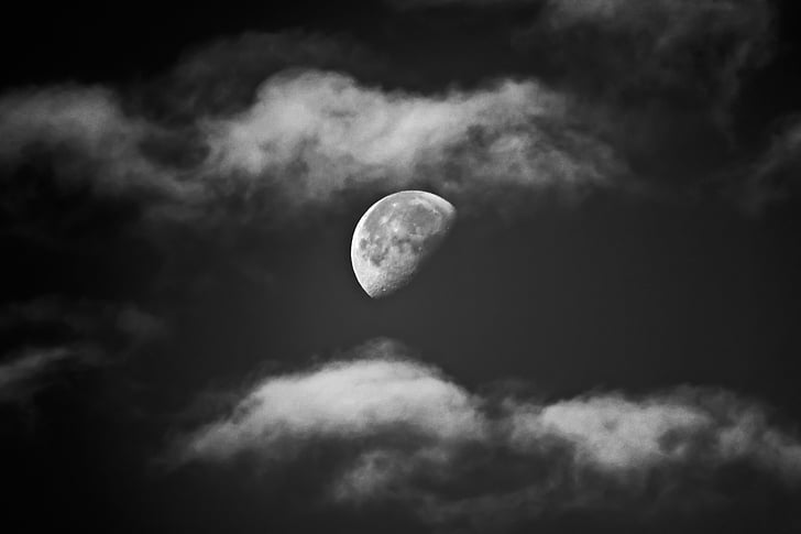 half moon on cloudy sky
