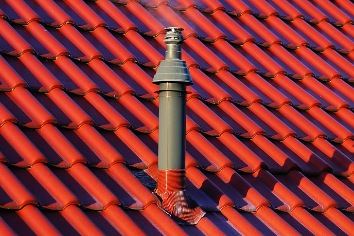 gray and red tube pipe on roof