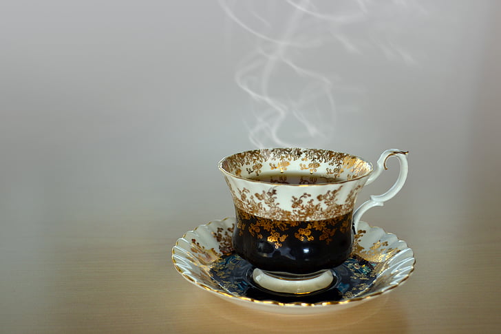 photography of white teacup filled with hot coffee