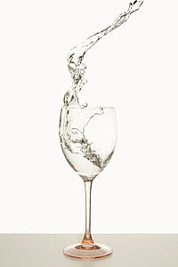 clear wine glass pouring clear liquid