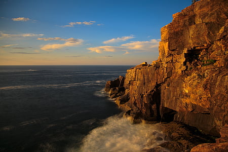 rock formation beside ocean during daytime
