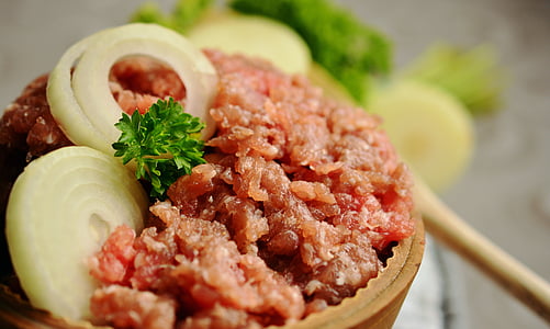 sliced onions on cooked meat