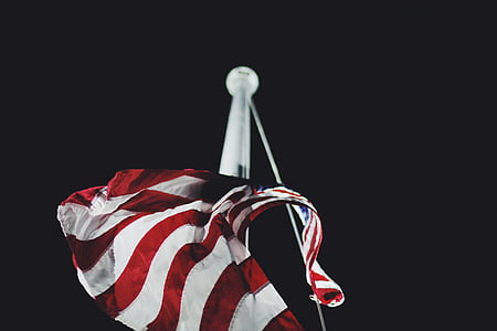 hanged U.S. flag on white pole