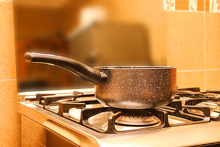 black cooking pot on gas range oven