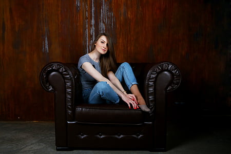 woman sitting on armchair