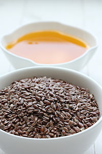 brown beans and orange liquid on white ceramic bowl
