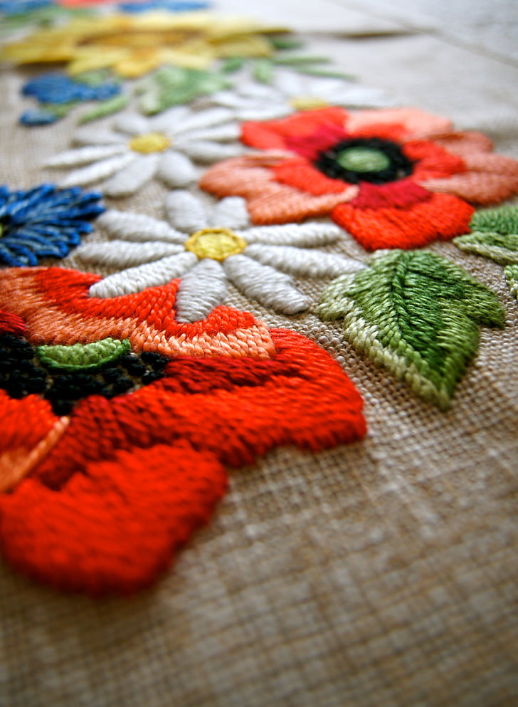 shallow focus photography of assorted-color floral embroidered textile