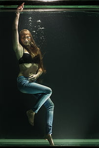 woman in black brassiere inside water tank