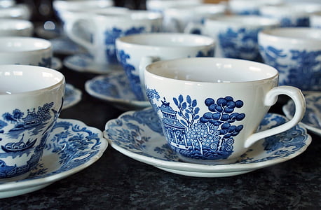 white and blue ceramic teacups and saucers