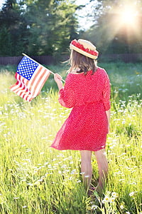 girl wearing red 3/4-sleeved mini dress holding u.s.a. flaglette