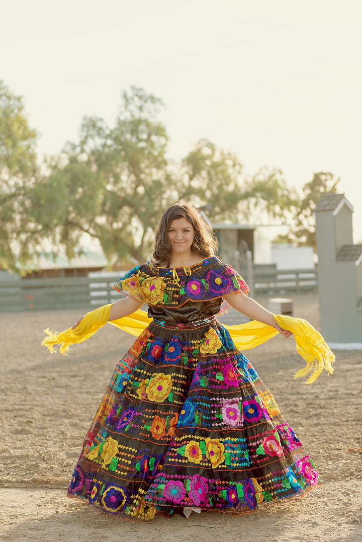 woman wearing multicolored dress standing