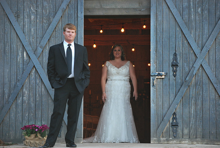 bride and groom standing on barnyard