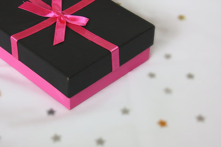closeup photo of black and pink box with bow accent