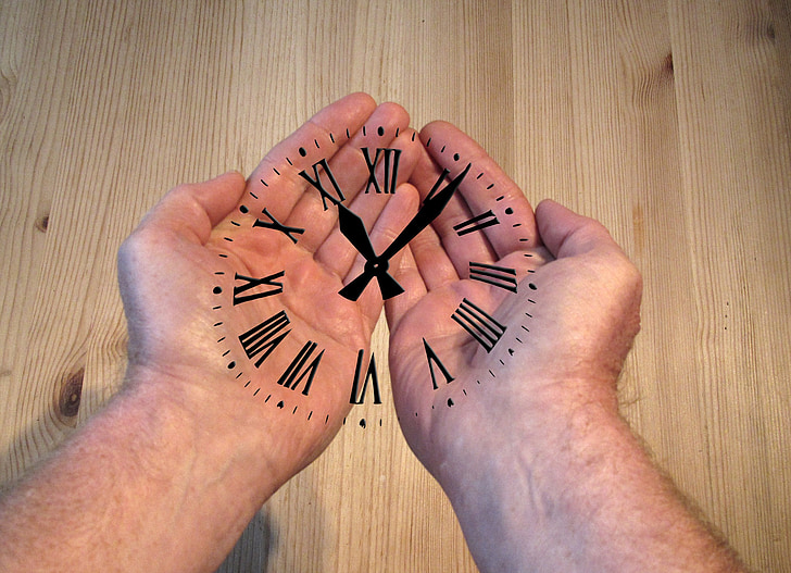 analog clock at person's hand
