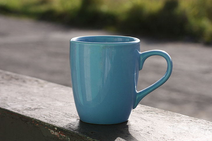 close up photography of green ceramic mug during day time