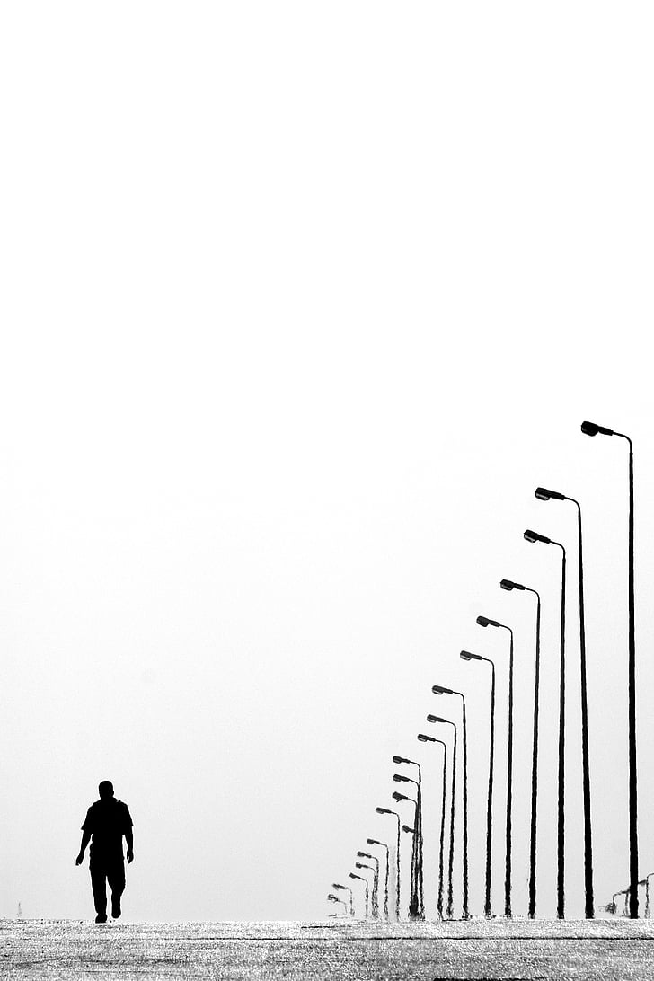 man waling on the street during daytime