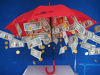 red umbrella with hanged US dollar banknotes