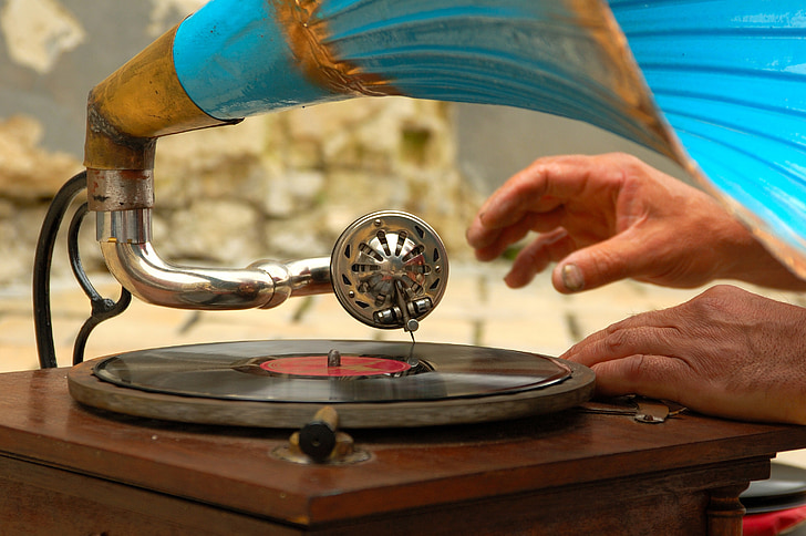 person touching gramophone