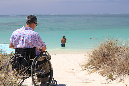 man sitting on wheelchair on seasire