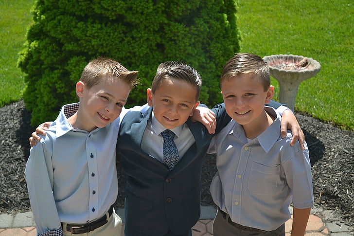 three boys taking a groupie