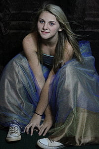 woman wearing blue and brown strapless gown sitting on black surface