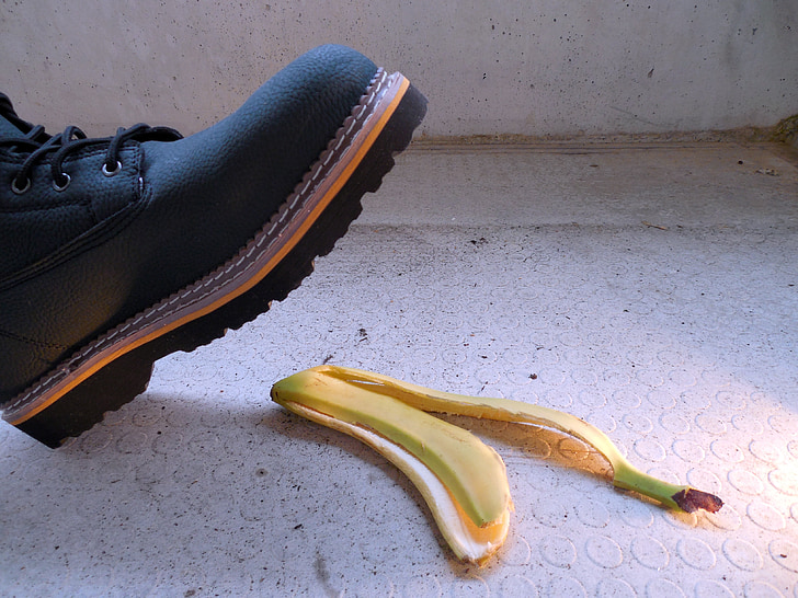 black leather work boot near yellow banana