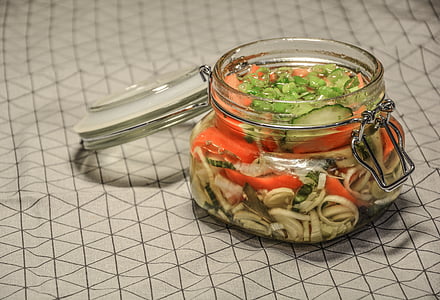 clear glass air tight jar filled with vegetables