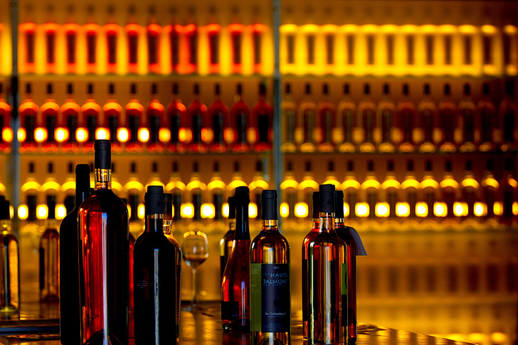liquor bottles near bottles on rack