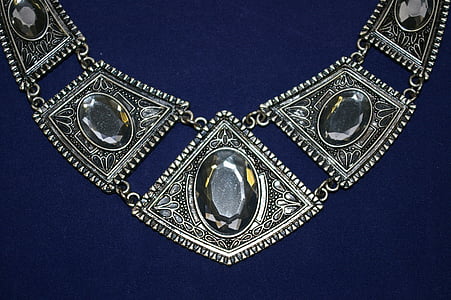 silver-colored necklace with clear gemstones