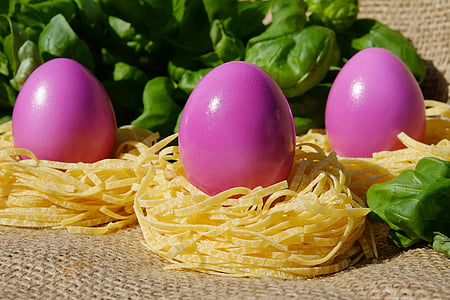 three pink poultry eggs on pasta