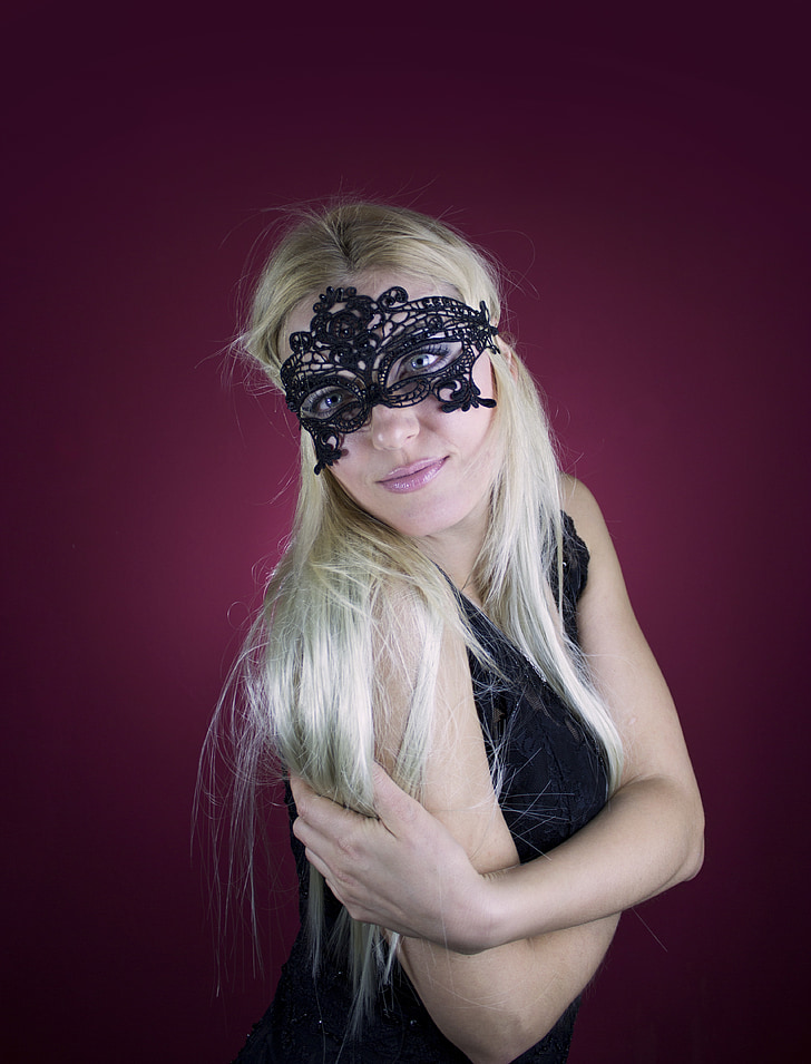 blonde haired woman in black floral lface mask