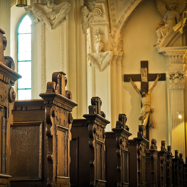 photo of church bench facing crucifix