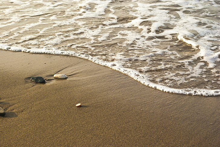 photo of brown sand in seashore
