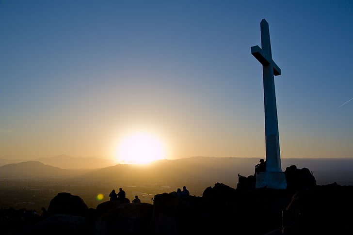 photo of white cross statue golden hour