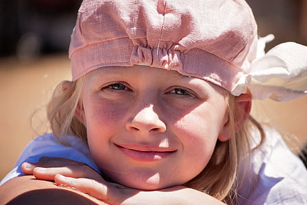 girl wearing white shirt and pink hat