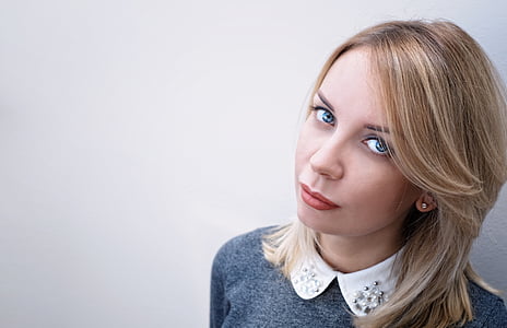blonde haired woman wearing gray space dye and white collared shirt