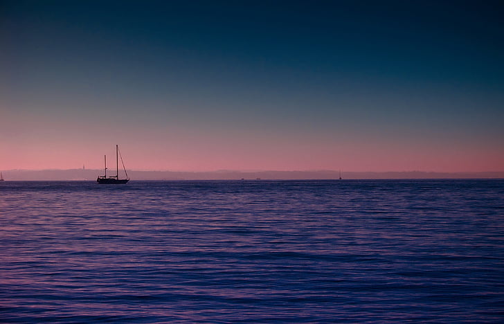 silhouette photo of ship on sea